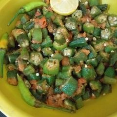A picture of Bhindi fry with tomato.