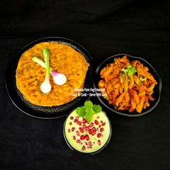 A picture of Multigrain Masala Paratha - Ivy Gourd Sabzi - Mint Pomegranate Dahi Raita.