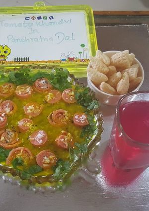 A picture of Red khandvi in yellow daal.