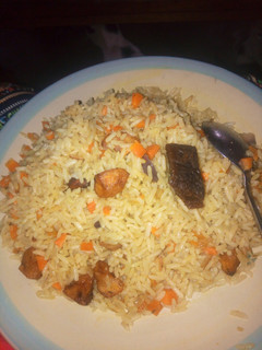 A picture of Fried Rice with chopped fried plantain.