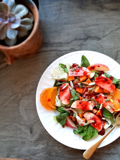 A picture of Mango peach salad with passion thyme vinaigrette.