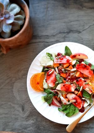A picture of Mango peach salad with passion thyme vinaigrette.