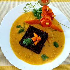 A picture of Ripe Mango Kadhi With Black Rice and Salad.
