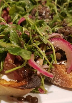 A picture of Lentil Salad Crostini with Chevre and Prosciutto.