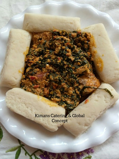 A picture of Egusi/ugu leaf soup with pounded yam.