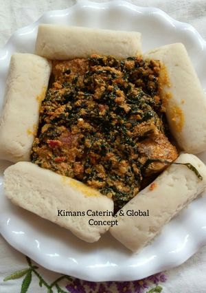 A picture of Egusi/ugu leaf soup with pounded yam.