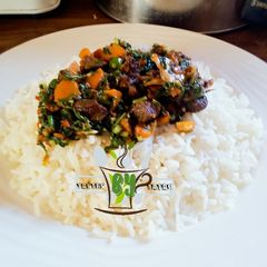 A picture of White rice with spinach sauce.