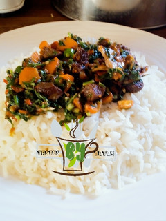 A picture of White rice with spinach sauce.