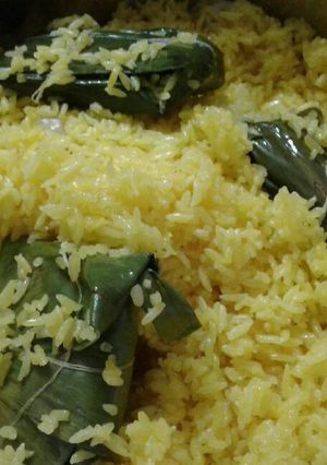 A picture of Patauri pulao (fried rice with stuffed banana leaf envelopes).