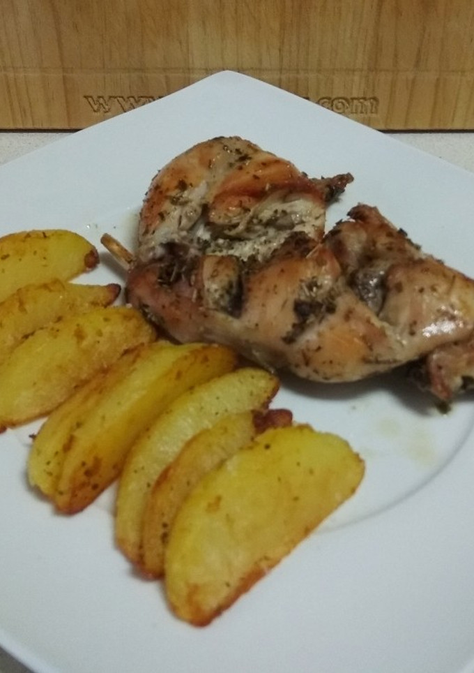 Una foto de Conejo asado con gajos de patata