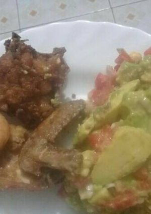 A picture of Deep fried chicken served with kachumbari.