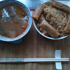 A picture of Japanese dice pork chop in gekkeikan sake rice wine. japanese sticky yakiniku sauce sezhuan spicy spring rolls egg fried rice home made.