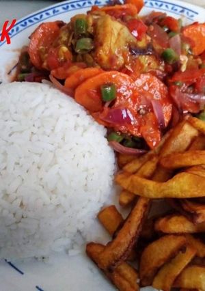 A picture of Rice with sauce and fried plantain.