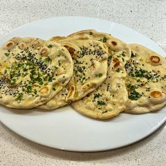 A picture of Onion seeds, garlic, parsley and butter naan.