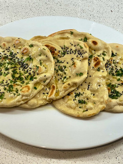 A picture of Onion seeds, garlic, parsley and butter naan.