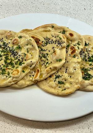 A picture of Onion seeds, garlic, parsley and butter naan.