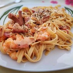 A picture of Shrimp Fettucine with bacon and sausage carbonara.