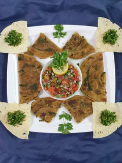 A picture of Masala paratha with salsa.