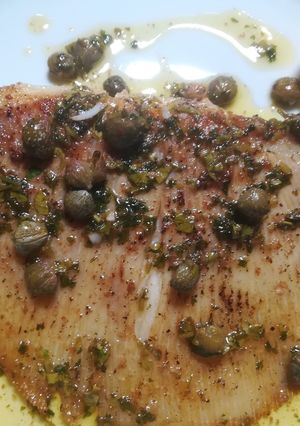 A picture of Skate wing with a brown butter and caper sauce.