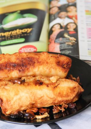 A picture of Ethapazham Nirachathu / Malabar Style Stuffed Plantain Fritters With Sweet Coconut Filling.