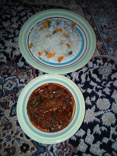A picture of Rice nd stew with spring onions inside the stew.