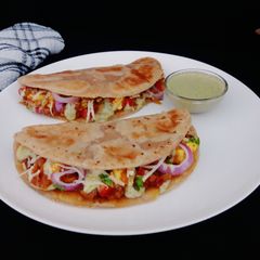 A picture of Paneer tikka paratha tacos.