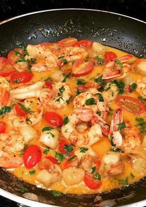 A picture of Shrimp and Scallops with Cherry Tomatoes.
