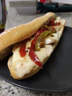 Una foto de 🥖 Bocadillo de pollo con salteado de pimientos y queso fundido
