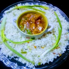A picture of Chicken chilli with stir fry veg rice.