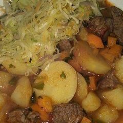 A picture of Beef stew and fried cabbage.