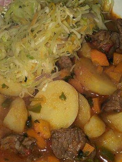 A picture of Beef stew and fried cabbage.