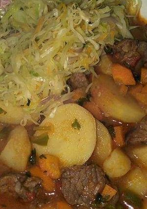 A picture of Beef stew and fried cabbage.