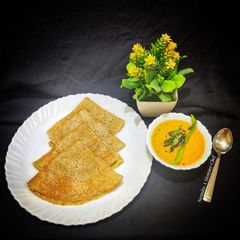 A picture of Black gram- multimillets dosa with tomato- onion chutney.