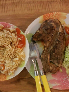A picture of Panfried steak served with fried rice and veges.