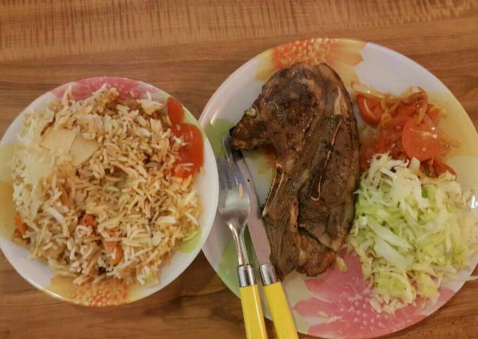 Panfried steak served with fried rice and veges