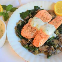 A picture of Salmon fillets with mushroom & spinach.