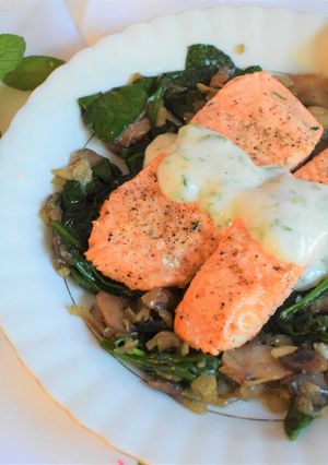 A picture of Salmon fillets with mushroom & spinach.