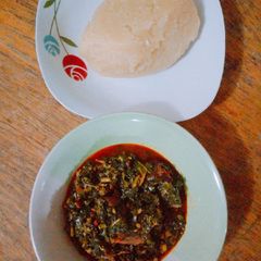 A picture of Vegetable soup and yellow garri.