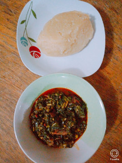 A picture of Vegetable soup and yellow garri.