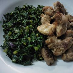 A picture of Fried beef with greens.