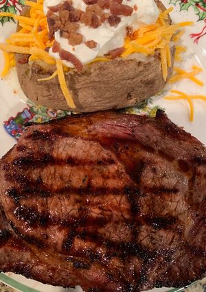 A picture of Texas Ribeye with a Baked Potato.