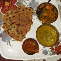 A picture of Stuffed green peas and paneer paratha with lauki.