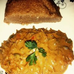 A picture of Omena cooked in coconut milk served with brown ugali.