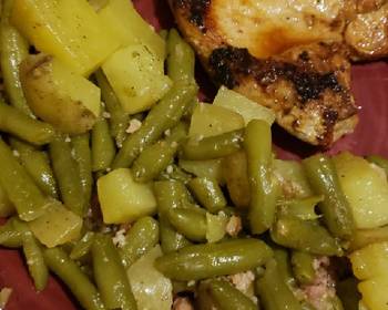 Unique Cuisine 1 pan potatoes and greenbeans with pan fried bonein pork chops Delicious