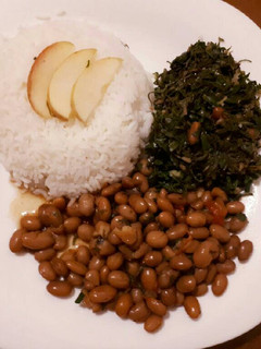 A picture of Rice served with beans and spinach.