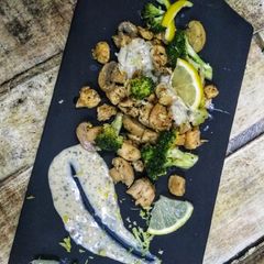 A picture of Lemon chicken, broccli and mushroom with double cheese sauce.