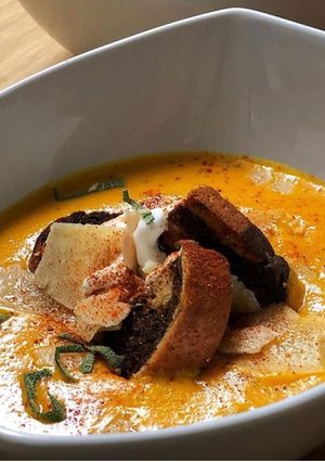 A picture of Roasted Sweet Potato & Carrot Soup with Marble Rye Croutons.