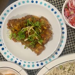 A picture of Chicken masala with peas pulao rice.
