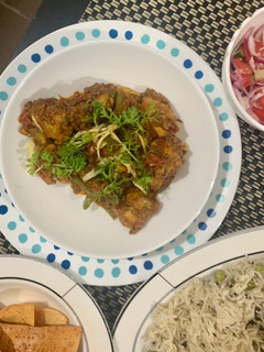 A picture of Chicken masala with peas pulao rice.