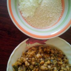 A picture of Beans porridge and spring onion plus garri, milk and sugar.